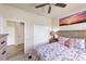 Cozy bedroom featuring a ceiling fan, closet, and inviting, colorful bedding at 19993 Benissimo Dr, Venice, FL 34293