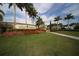 Community entrance sign, surrounded by lush landscaping and tall palm trees at 19993 Benissimo Dr, Venice, FL 34293