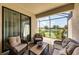 Outdoor living area with comfortable seating and a view of the serene lake at 19993 Benissimo Dr, Venice, FL 34293
