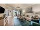Spacious living room with sliding glass doors and a modern chandelier at 19993 Benissimo Dr, Venice, FL 34293