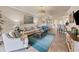 Inviting living room with chandelier offers an open floor plan to the dining area at 19993 Benissimo Dr, Venice, FL 34293