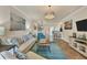 Comfortable living room featuring a chandelier, and an open floor plan at 19993 Benissimo Dr, Venice, FL 34293