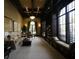 Community lounge area with comfortable seating, bookshelves, and large arched windows at 19993 Benissimo Dr, Venice, FL 34293