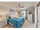 Well-lit main bedroom with ceiling fan, soft hues, and dresser, creating a tranquil atmosphere at 19993 Benissimo Dr, Venice, FL 34293