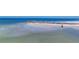 Scenic beach with soft sand and a natural rock barrier, offering a serene coastal escape at 2100 Benjamin Franklin Dr # 104, Sarasota, FL 34236