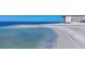 Beautiful view of beach with the condo building in the background on a bright sunny day at 2100 Benjamin Franklin Dr # 104, Sarasota, FL 34236