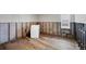 Spacious laundry room with wood-look tile flooring awaiting sheetrock at 2100 Benjamin Franklin Dr # 104, Sarasota, FL 34236