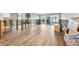 An unfinished living room with open access to the outside with wood floors at 2100 Benjamin Franklin Dr # 104, Sarasota, FL 34236