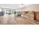 An unfinished living room with open access to the outside and wood floors at 2100 Benjamin Franklin Dr # 104, Sarasota, FL 34236
