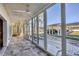 Spacious patio featuring sliding glass doors and ceiling fan, perfect for outdoor entertaining at 2100 Benjamin Franklin Dr # 104, Sarasota, FL 34236