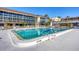 Community pool area with seating and lush landscaping, perfect for relaxation at 2100 Benjamin Franklin Dr # 104, Sarasota, FL 34236
