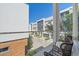 Balcony view with modern outdoor seating overlooking landscaped community at 232 Cosmopolitan Ct, Sarasota, FL 34236