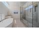 Bathroom with sleek shower, soaking tub, and modern design at 232 Cosmopolitan Ct, Sarasota, FL 34236