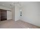 Bedroom features neutral carpet, modern closet, and abundant natural light at 232 Cosmopolitan Ct, Sarasota, FL 34236