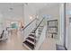 Inviting entryway features a staircase, glass railing, abundant natural light, and an office area in view at 232 Cosmopolitan Ct, Sarasota, FL 34236