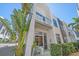 Stunning exterior view of a modern home with a balcony and beautifully landscaped surroundings at 232 Cosmopolitan Ct, Sarasota, FL 34236
