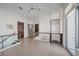 Hallway with glass railings, tiled floors, and elevator access at 232 Cosmopolitan Ct, Sarasota, FL 34236