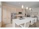 Well-lit kitchen showcases stainless steel appliances, an island with seating, and contemporary cabinetry at 232 Cosmopolitan Ct, Sarasota, FL 34236
