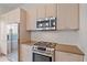 Modern kitchen features stainless steel appliances, a sleek range, and stylish cabinets for culinary enthusiasts at 232 Cosmopolitan Ct, Sarasota, FL 34236
