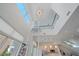 Bright, modern living room featuring high ceilings, a unique chandelier, and an accessible home elevator at 232 Cosmopolitan Ct, Sarasota, FL 34236