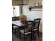 A dining room showcasing a wooden table, black chairs, and decorative shelving at 2330 Canal Dr # G27, Bradenton, FL 34207