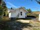 Inviting backyard featuring a quaint home with trees, offering a private outdoor space, and partial driveway at 2530 9Th W Ave, Bradenton, FL 34205