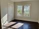 Sunlit bedroom with hardwood floors and a view of the outdoors from two windows at 2530 9Th W Ave, Bradenton, FL 34205