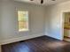 Bright bedroom boasts hardwood floors, white trim, and a large window overlooking the yard at 2530 9Th W Ave, Bradenton, FL 34205
