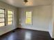 The bedroom features hardwood floors and three bright windows at 2530 9Th W Ave, Bradenton, FL 34205