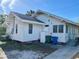 Charming exterior view of a cozy home with a clean white facade, bright sunlight, and neat landscaping at 2530 9Th W Ave, Bradenton, FL 34205