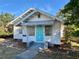 Charming home with a bright turquoise door and well-maintained front yard, creating an inviting curb appeal at 2530 9Th W Ave, Bradenton, FL 34205