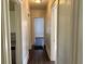 Hallway featuring hardwood floors and doors leading to various rooms at 2530 9Th W Ave, Bradenton, FL 34205