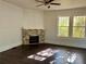 Bright living room featuring a brick fireplace, ceiling fan, and plenty of natural light at 2530 9Th W Ave, Bradenton, FL 34205