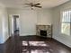 Cozy living room with a ceiling fan, hardwood floors, and a charming fireplace at 2530 9Th W Ave, Bradenton, FL 34205