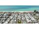 Community aerial view with beach, tennis court and pool near the ocean offering vacation living at 2601 Gulf N Dr # 221, Bradenton Beach, FL 34217