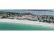 Aerial view of beachfront properties and the tranquil ocean showcasing coastal living at its finest at 2601 Gulf N Dr # 221, Bradenton Beach, FL 34217