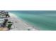 Beautiful aerial view showcasing the beach, turquoise ocean, and nearby homes at 2601 Gulf N Dr # 221, Bradenton Beach, FL 34217