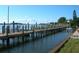 Long wooden dock with pilings on the water, perfect for boating and enjoying waterfront living at 2601 Gulf N Dr # 221, Bradenton Beach, FL 34217