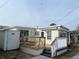 Charming home featuring a wooden deck with awning for relaxing or entertaining outdoors at 2601 Gulf N Dr # 221, Bradenton Beach, FL 34217