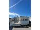 Charming exterior view of home featuring a quaint deck and light siding under a bright blue sky at 2601 Gulf N Dr # 221, Bradenton Beach, FL 34217