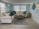 Inviting living room with light blue walls, comfortable seating, and natural light at 2601 Gulf N Dr # 221, Bradenton Beach, FL 34217