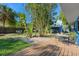 Expansive backyard with lush greenery, patio area with outdoor seating, and privacy fence for relaxation and entertaining at 2728 Trinidad St, Sarasota, FL 34231