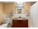 The renovated bathroom features a granite countertop, wood vanity, and shower with a curtain at 2728 Trinidad St, Sarasota, FL 34231