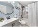 Modern bathroom features a sleek vanity, updated fixtures, and shower with decorative tile and glass block window at 2728 Trinidad St, Sarasota, FL 34231