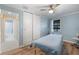 Bright bedroom featuring an adjustable massage table, wood laminate flooring, and natural light through bright windows at 2728 Trinidad St, Sarasota, FL 34231