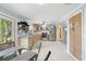 Spacious kitchen and dining area with stainless steel appliances, light wood cabinetry, and white tile flooring at 2728 Trinidad St, Sarasota, FL 34231