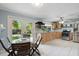 Open kitchen and dining area with glass top table, stainless steel appliances, and natural light at 2728 Trinidad St, Sarasota, FL 34231