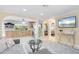 Open-concept living room with tile floors, neutral colors, and sightlines to the kitchen and bedroom at 2728 Trinidad St, Sarasota, FL 34231