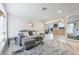 Well-lit living room with geometric wallpaper, contemporary furniture, and view of kitchen at 2728 Trinidad St, Sarasota, FL 34231