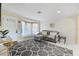 Cozy living room featuring a large window seat, stylish decor, and ample natural light at 2728 Trinidad St, Sarasota, FL 34231